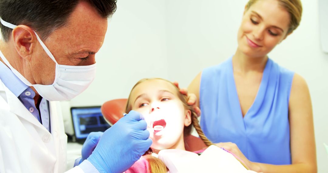 Dentist Examining Young Girl's Teeth During Dental Checkup - Free Images, Stock Photos and Pictures on Pikwizard.com