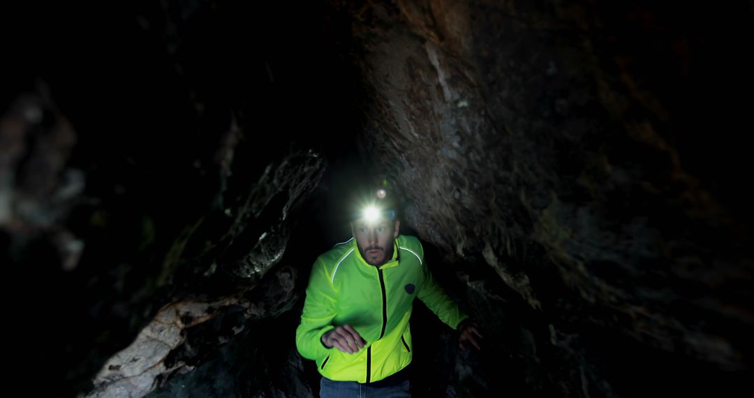 Explorer with Headlamp Venturing Through Underground Cave - Free Images, Stock Photos and Pictures on Pikwizard.com