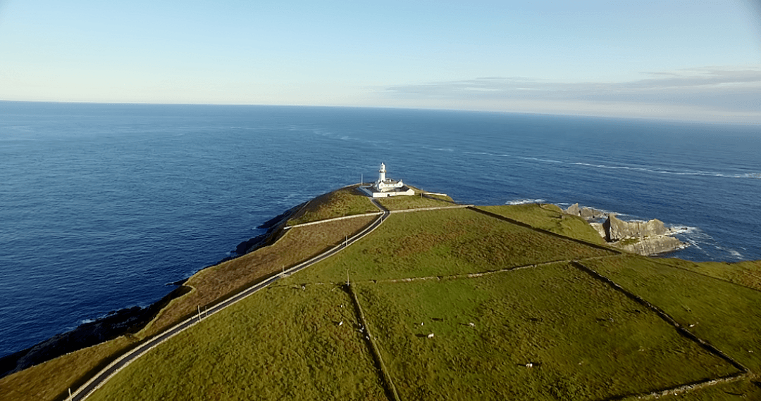 Breathtaking Transparent Horizon Over Clifftop Lighthouse on Sunny Day