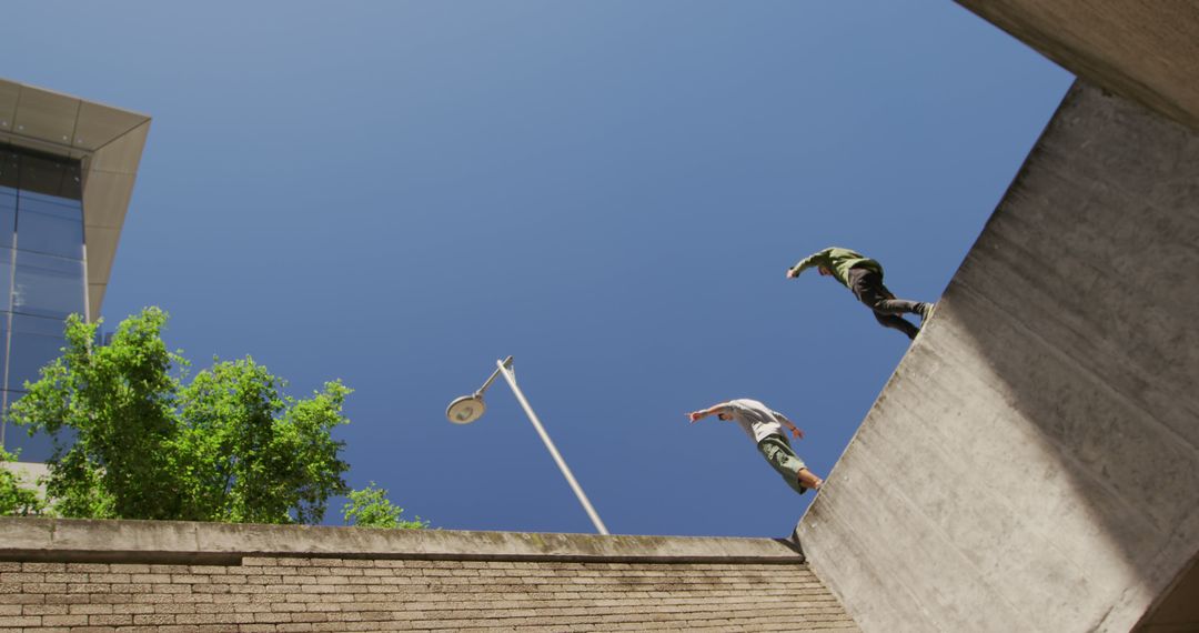 Urban Freedoms: Parkour Practitioners Jumping Across Buildings - Free Images, Stock Photos and Pictures on Pikwizard.com