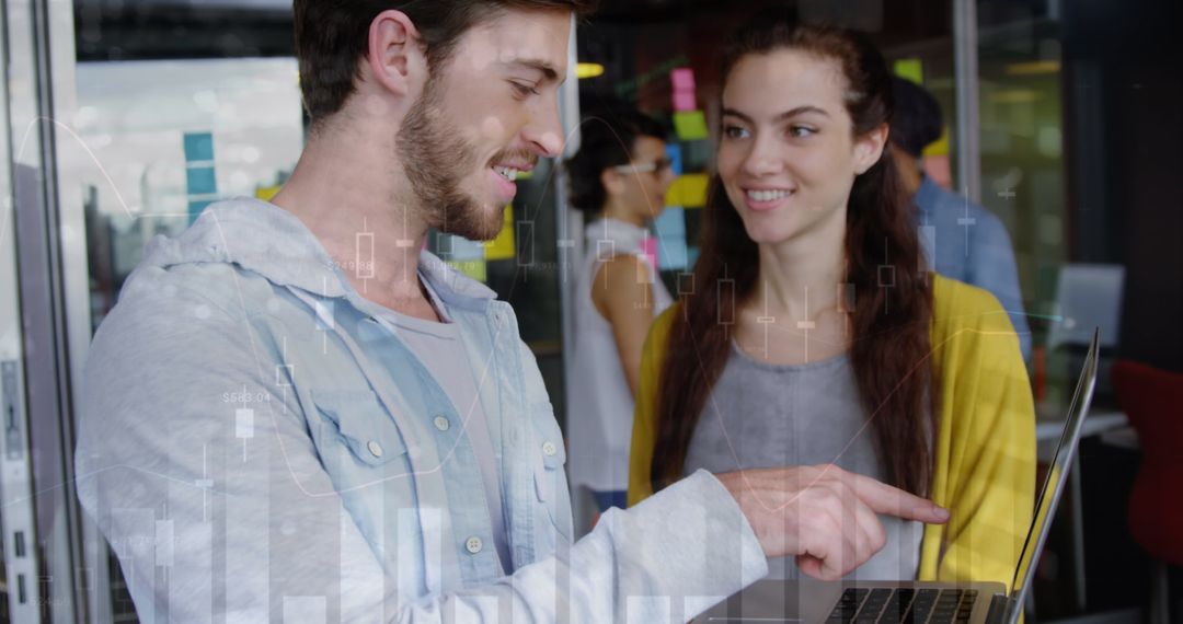 Business Team Analyzing Financial Reports on Laptop in Modern Office