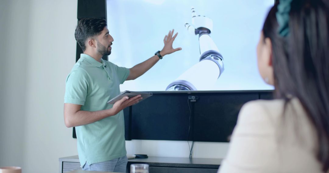 Businessman Pointing at Robot Arm Presentation in Meeting