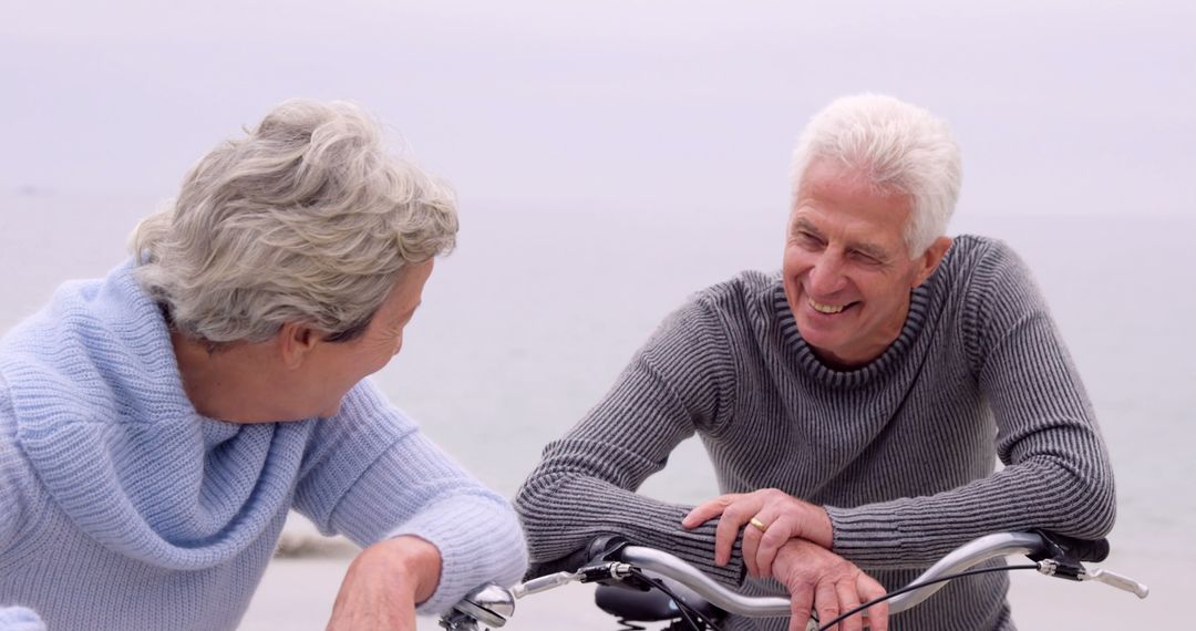 Happy Senior Couple Enjoying a Bike Ride Near Beach - Free Images, Stock Photos and Pictures on Pikwizard.com