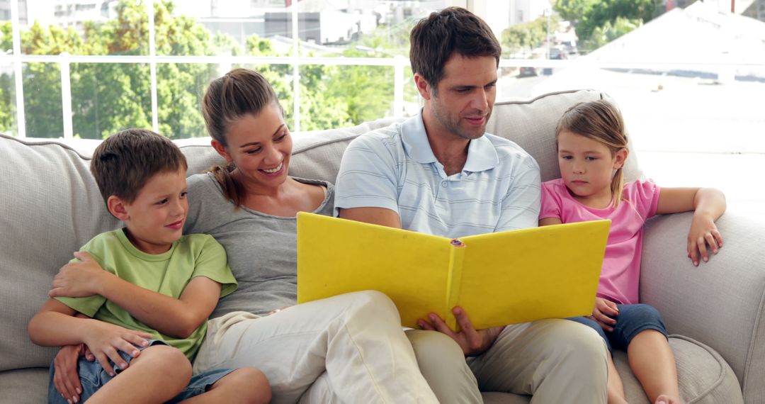 Parents Reading With Children on Couch at Home - Free Images, Stock Photos and Pictures on Pikwizard.com