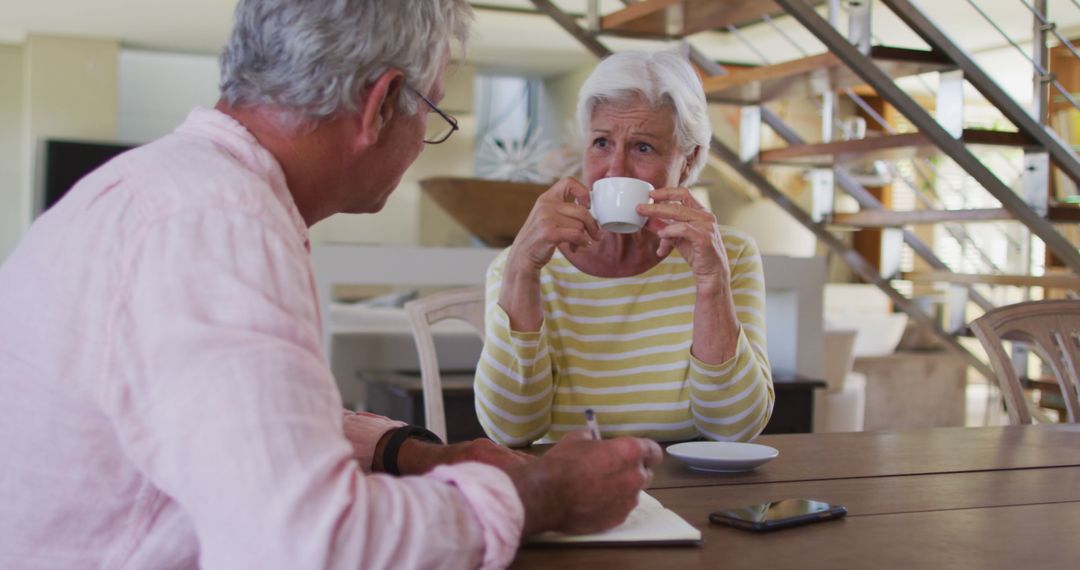Senior Couple Discussing Finances at Home Over Coffee