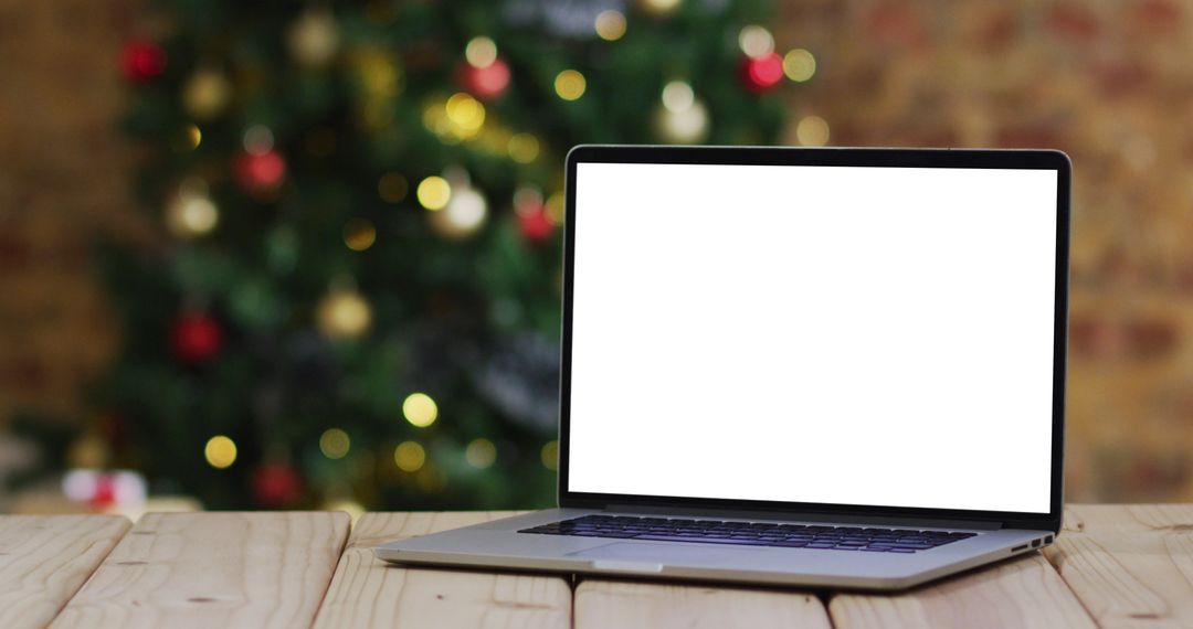 Laptop with Blank Screen and Christmas Tree Background