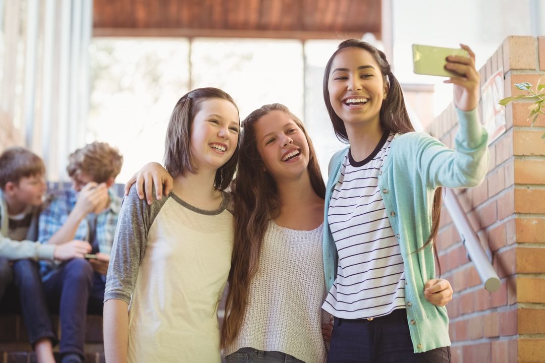Smiling Schoolgirls Taking Selfie in School Corridor - Free Images, Stock Photos and Pictures on Pikwizard.com
