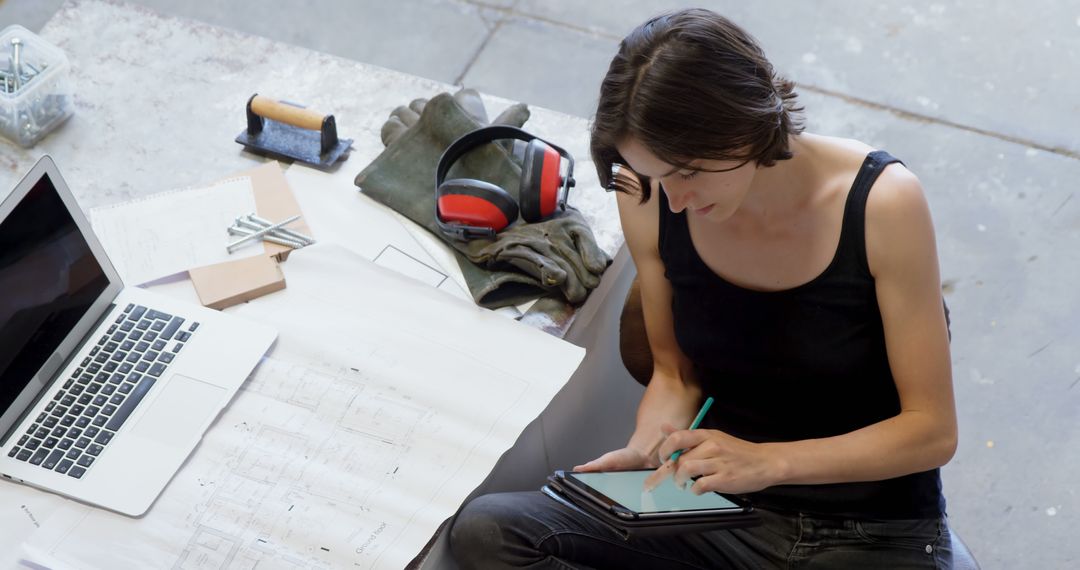 Female Engineer Using Tablet in Workshop - Free Images, Stock Photos and Pictures on Pikwizard.com