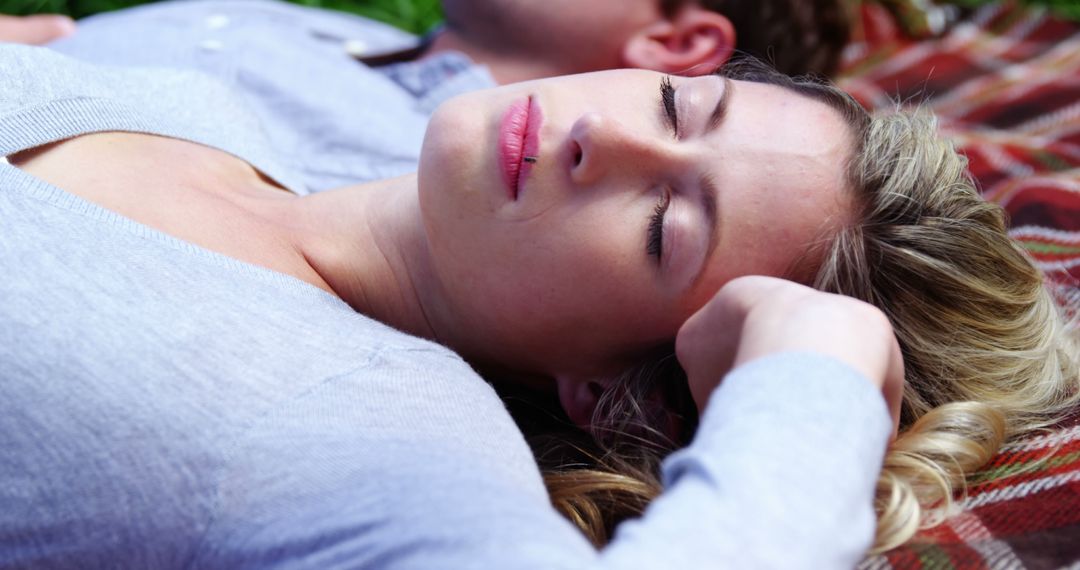 Woman Relaxing Outdoors on a Plaid Blanket - Free Images, Stock Photos and Pictures on Pikwizard.com