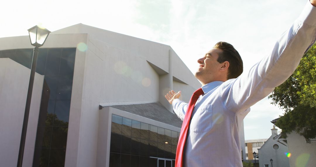 Happy businessman with open arms enjoying success outdoors - Free Images, Stock Photos and Pictures on Pikwizard.com