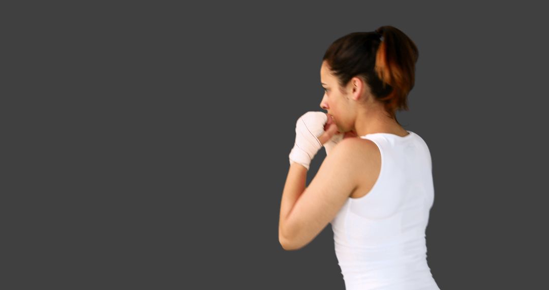 Female Boxer in White Gear Practicing Against Gray Background - Free Images, Stock Photos and Pictures on Pikwizard.com