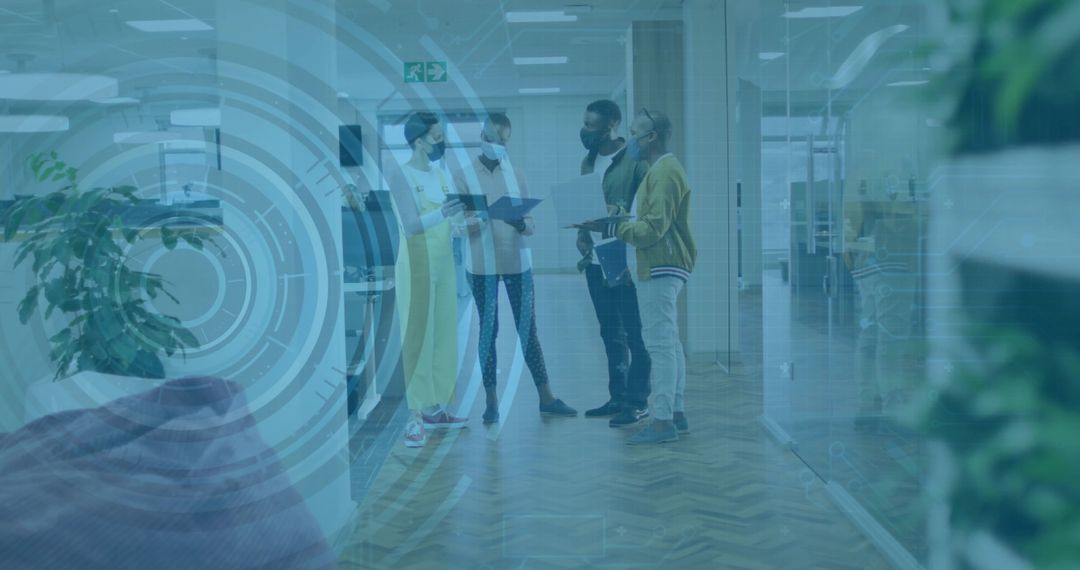 Team standing in modern office corridor discussing documents with tablet HUD overlay