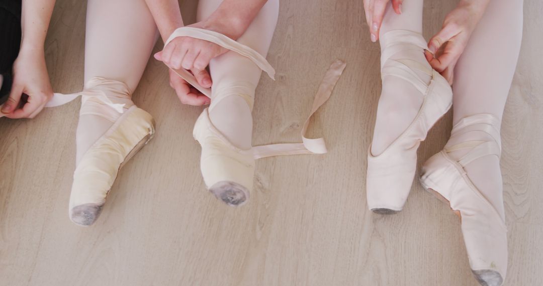 Ballet Dancers Adjusting Pointe Shoes Before Practice - Free Images, Stock Photos and Pictures on Pikwizard.com