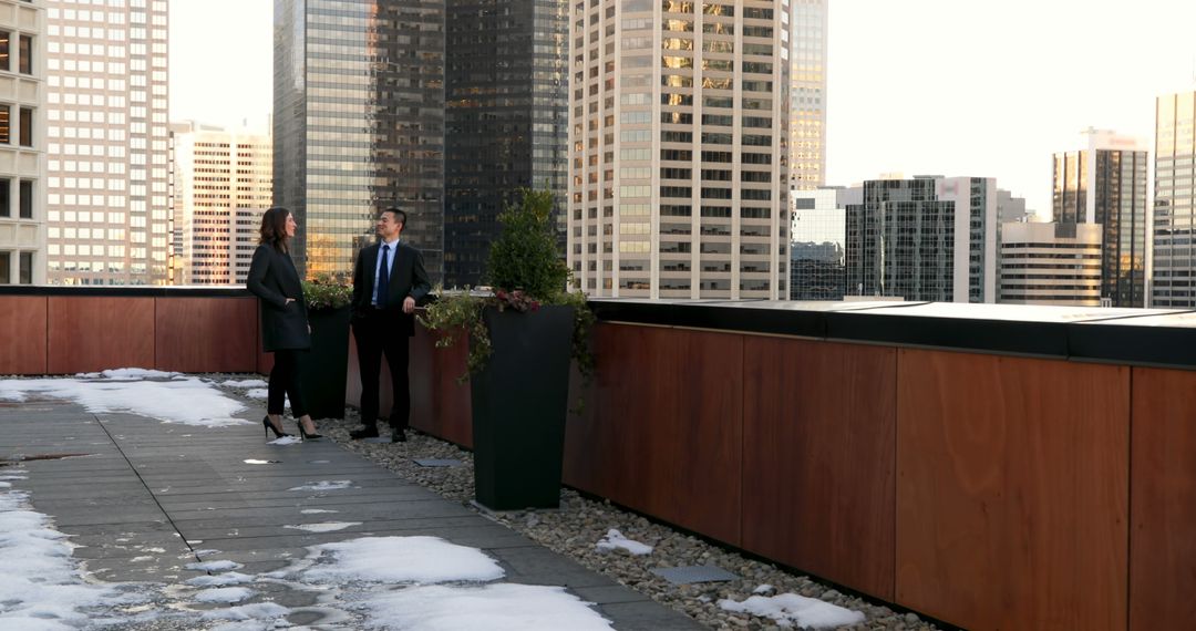 Professionals Having Conversation on Office Rooftop in City - Free Images, Stock Photos and Pictures on Pikwizard.com