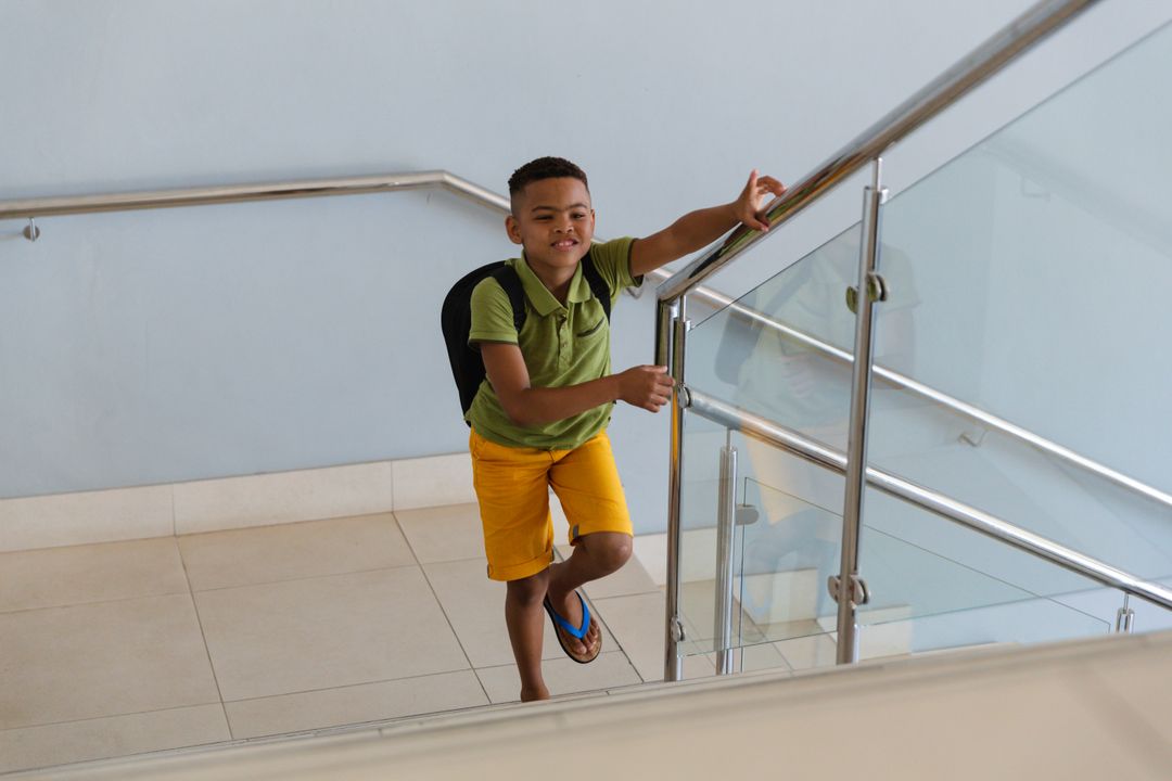 Smiling African American Boy Climbing School Stairs - Free Images, Stock Photos and Pictures on Pikwizard.com