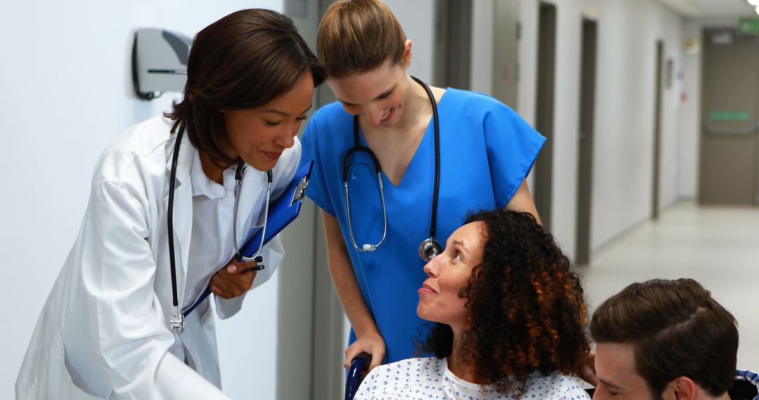 Medical Team Assisting Female Patient in Wheelchair - Free Images, Stock Photos and Pictures on Pikwizard.com