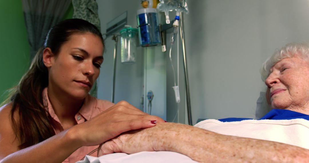 Young woman comforting elderly patient in hospital room - Free Images, Stock Photos and Pictures on Pikwizard.com