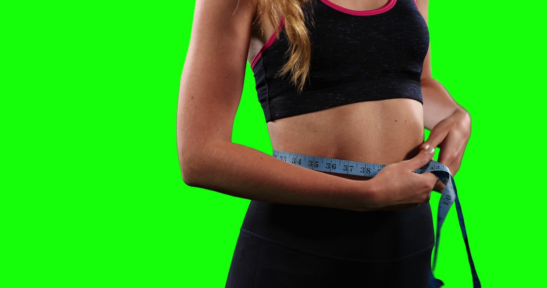 Woman Measuring Waistline with Tape Measure on Green Screen - Free Images, Stock Photos and Pictures on Pikwizard.com