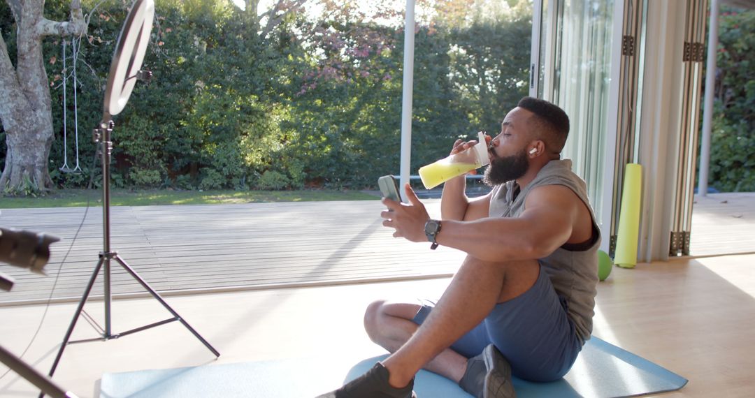 Fitness Enthusiast Drinking Smoothie During Home Workout - Free Images, Stock Photos and Pictures on Pikwizard.com