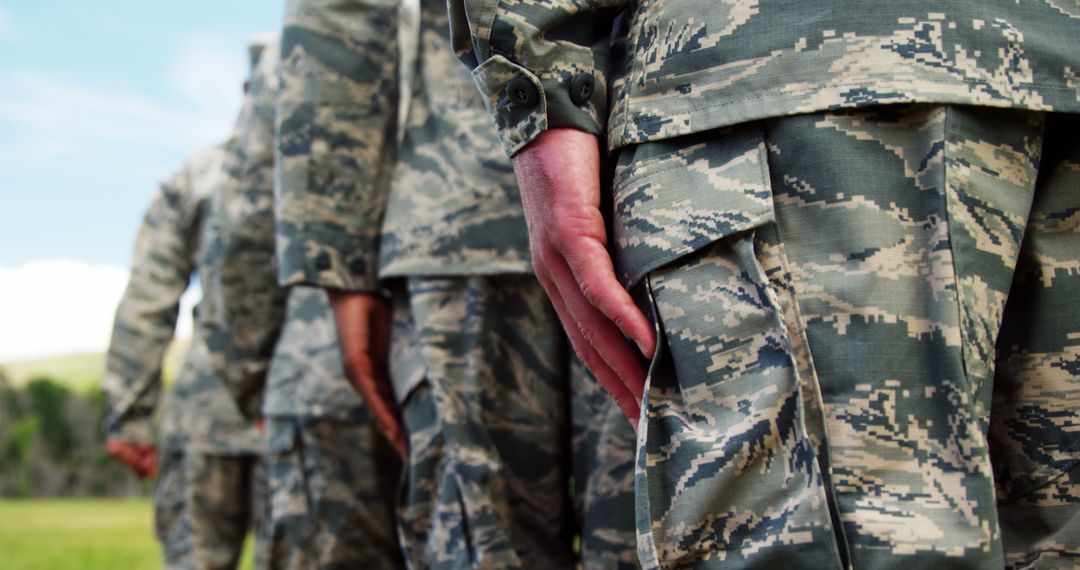Military Personnel in Line With Camouflage Uniforms Displaying Readiness