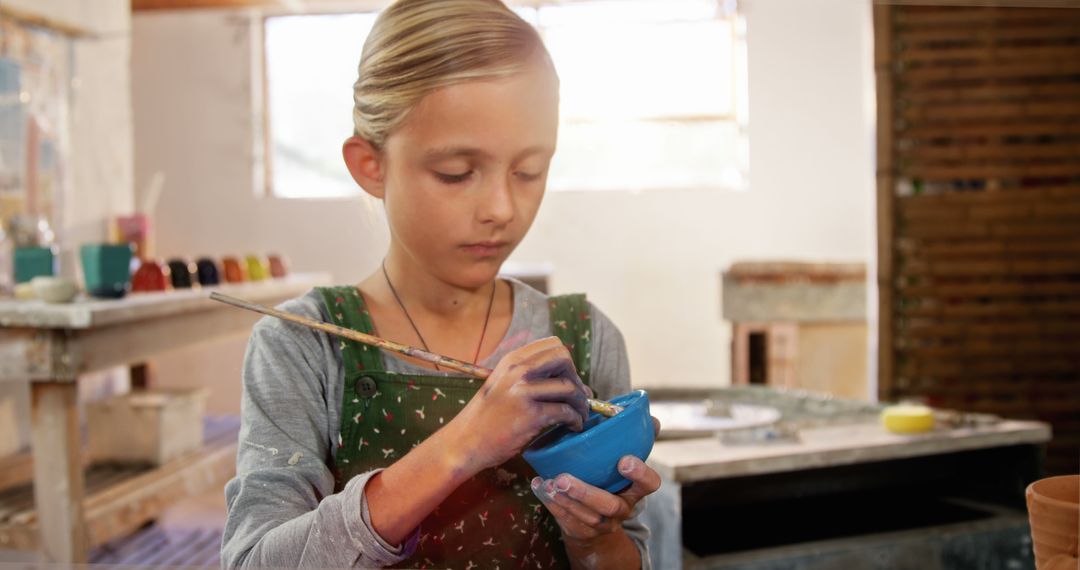 Young Girl Painting Pottery in Art Studio - Free Images, Stock Photos and Pictures on Pikwizard.com