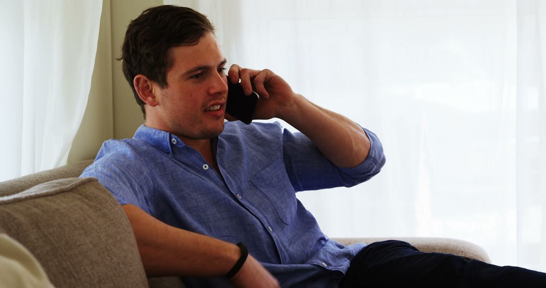 Man Relaxing on Couch While Talking on Phone - Free Images, Stock Photos and Pictures on Pikwizard.com