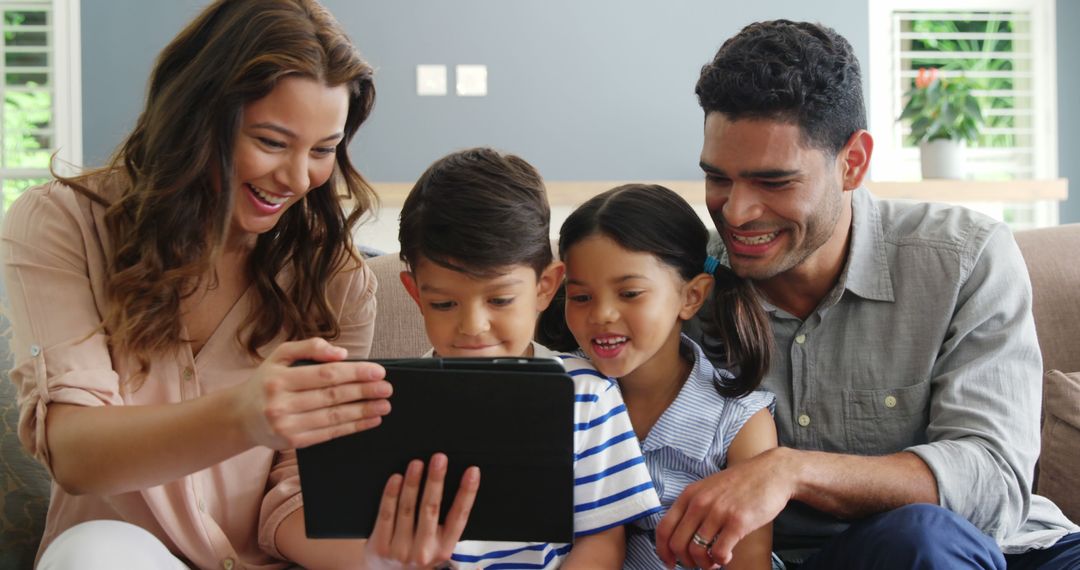 Happy Family Using Tablet PC at Home - Free Images, Stock Photos and Pictures on Pikwizard.com