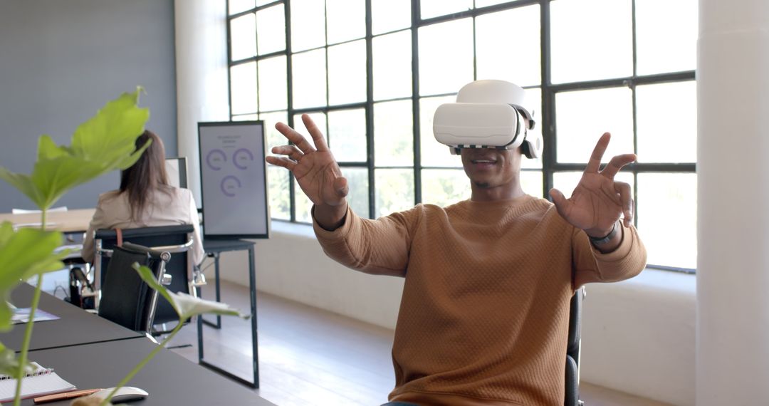 Man Exploring Virtual Reality with VR Headset in Modern Office