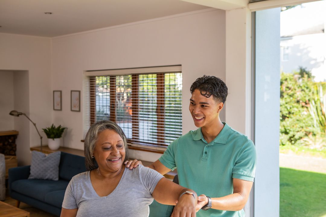 Son Assists Senior Mother with Stretching at Home
