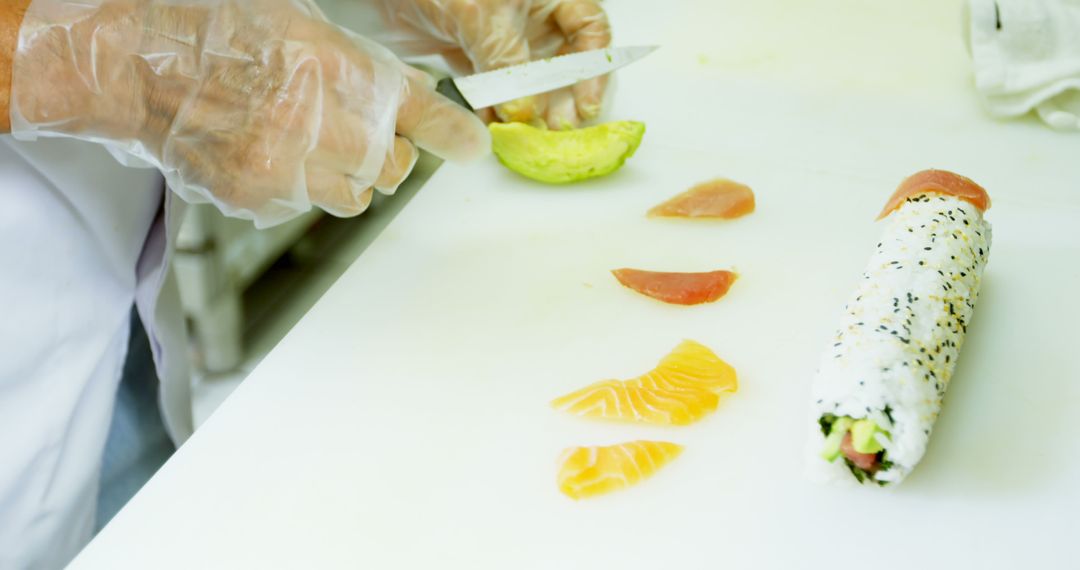 Chef Preparing Fresh Sushi Roll with Assorted Fish and Avocado - Free Images, Stock Photos and Pictures on Pikwizard.com