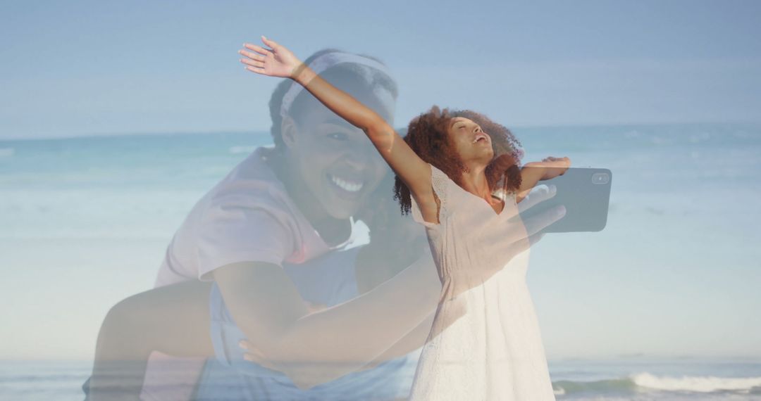 Ecstatic woman on beach with phone capturing joyful moments