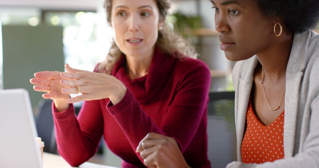 Two Diverse Businesswomen Collaborating in Modern Office