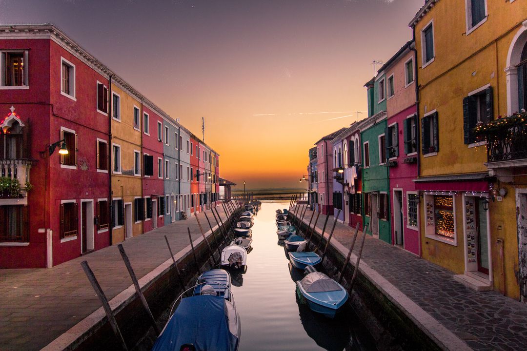 Colorful Canal Houses Along Sunset Waterfront in Burano, Italy - Free Images, Stock Photos and Pictures on Pikwizard.com