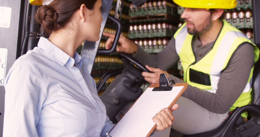 Warehouse Supervisor Checking Forklift Operator with Clipboard - Free Images, Stock Photos and Pictures on Pikwizard.com