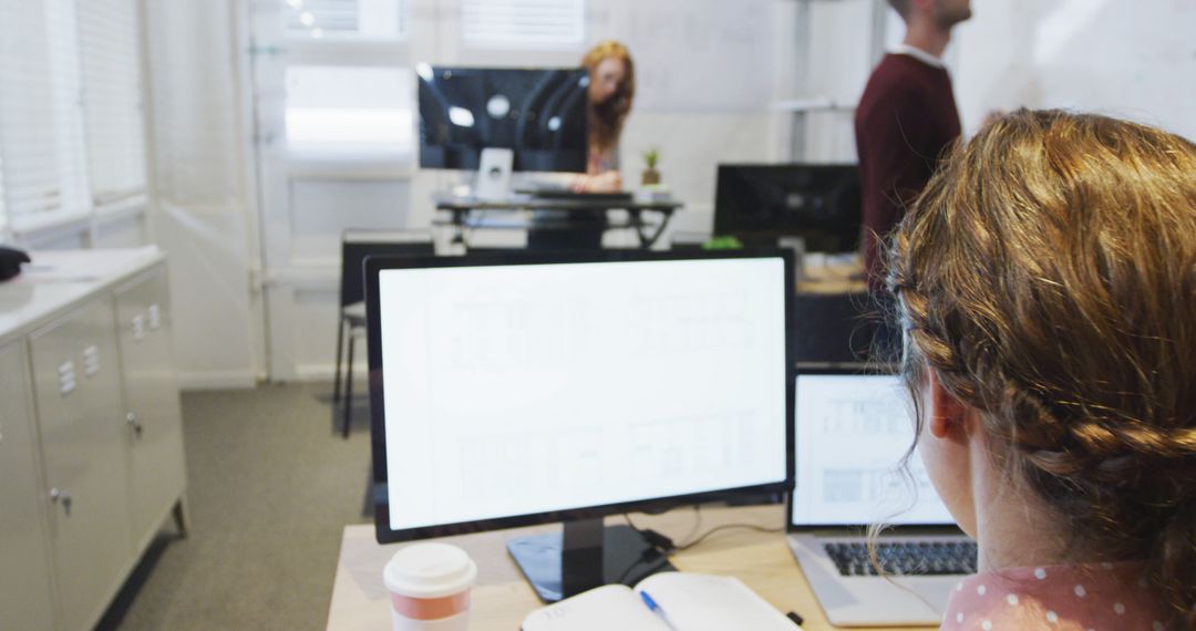 Professionals Collaborating on Architectural Project in Modern Office