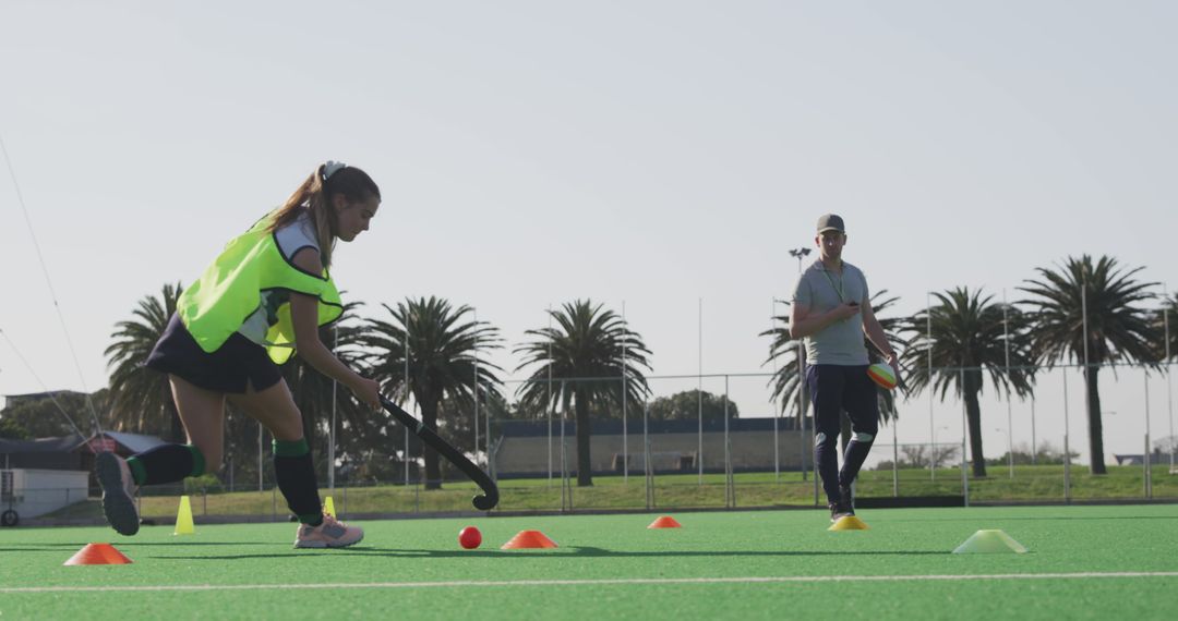 Female Field Hockey Player Training with Coach on Turf Field - Free Images, Stock Photos and Pictures on Pikwizard.com