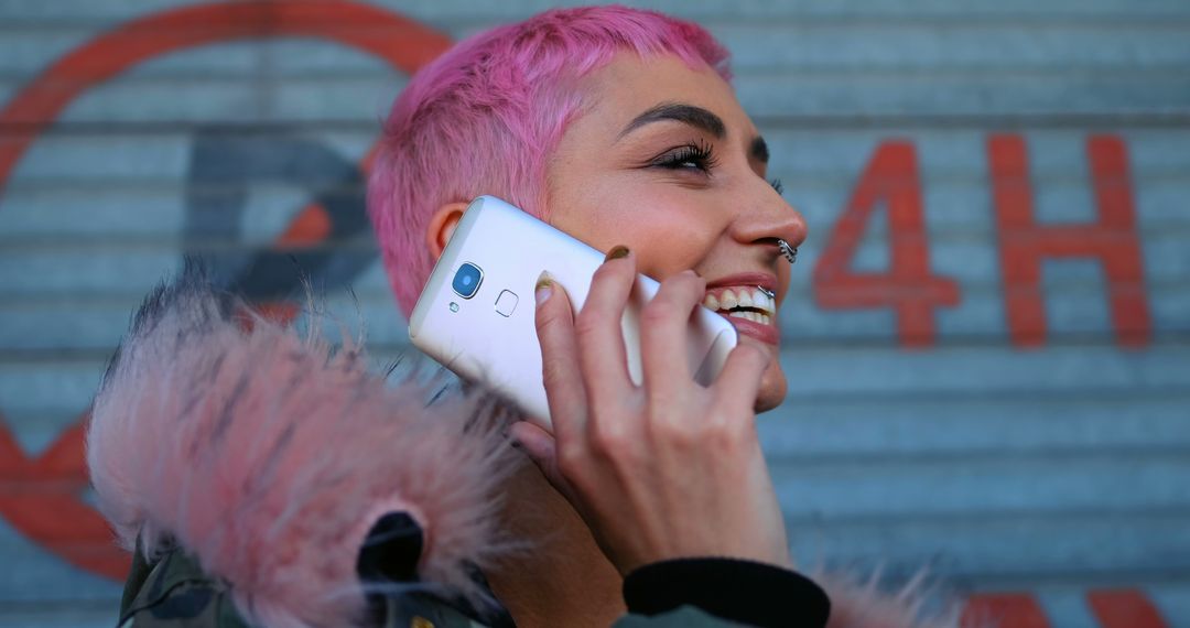 Young woman with pink hair talking on smartphone - Free Images, Stock Photos and Pictures on Pikwizard.com