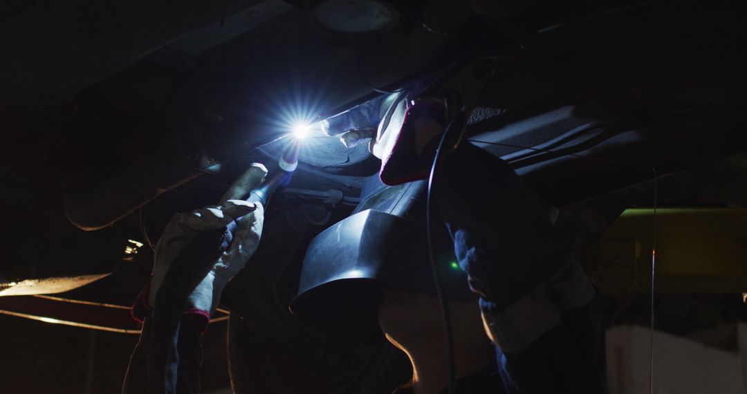 Mechanic Repairing Vehicle in Dark Garage with Flashlight - Free Images, Stock Photos and Pictures on Pikwizard.com