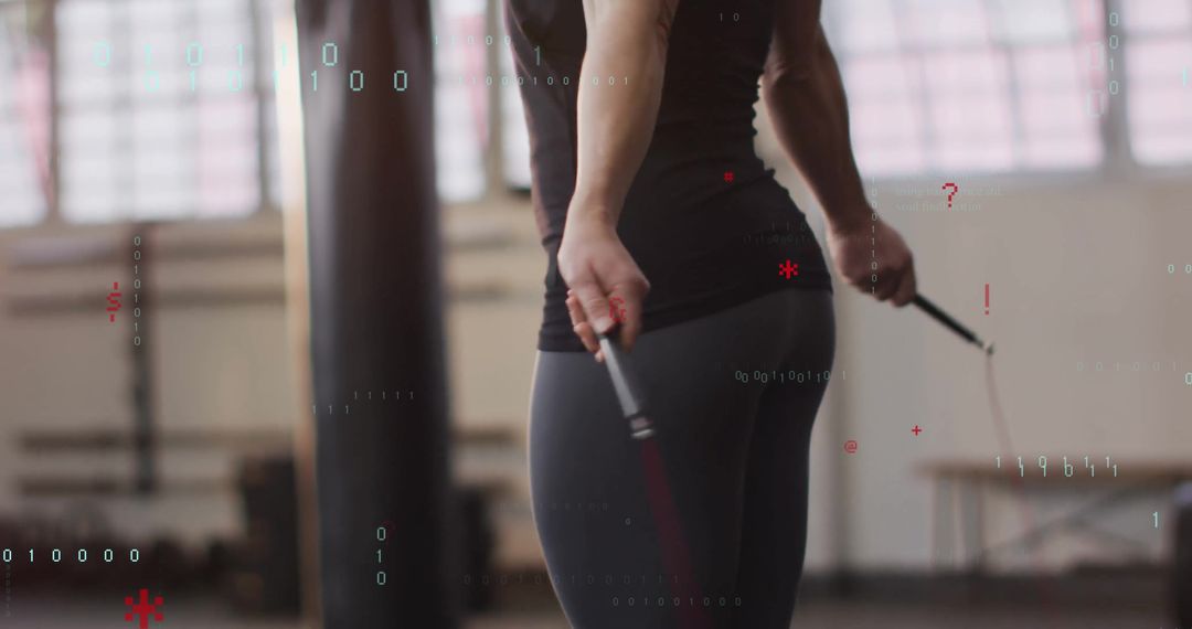 Athlete Skipping Rope in Gym with Punching Bag Background