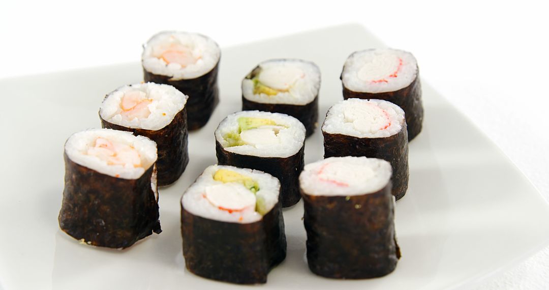 A plate of sushi rolls is presented against a white background, with copy space - Free Images, Stock Photos and Pictures on Pikwizard.com