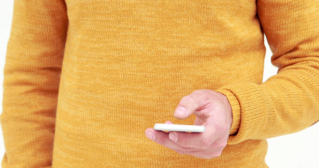 Person Using Smartphone in Casual Yellow Sweater - Free Images, Stock Photos and Pictures on Pikwizard.com