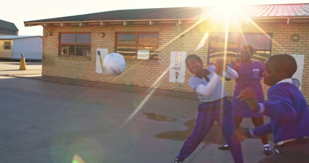 Children Playing Outside at School with Sun Flare - Free Images, Stock Photos and Pictures on Pikwizard.com