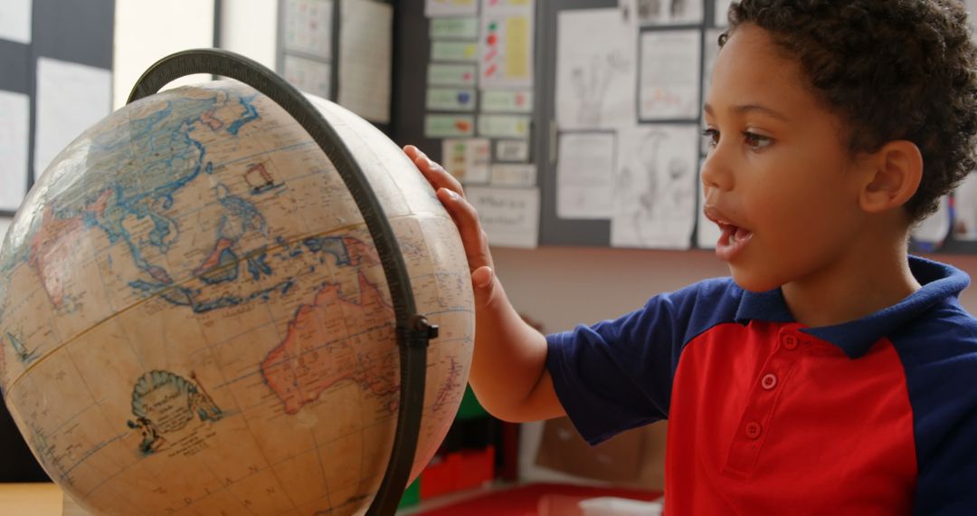 Curious Schoolboy Exploring World Globe in Classroom Setting
