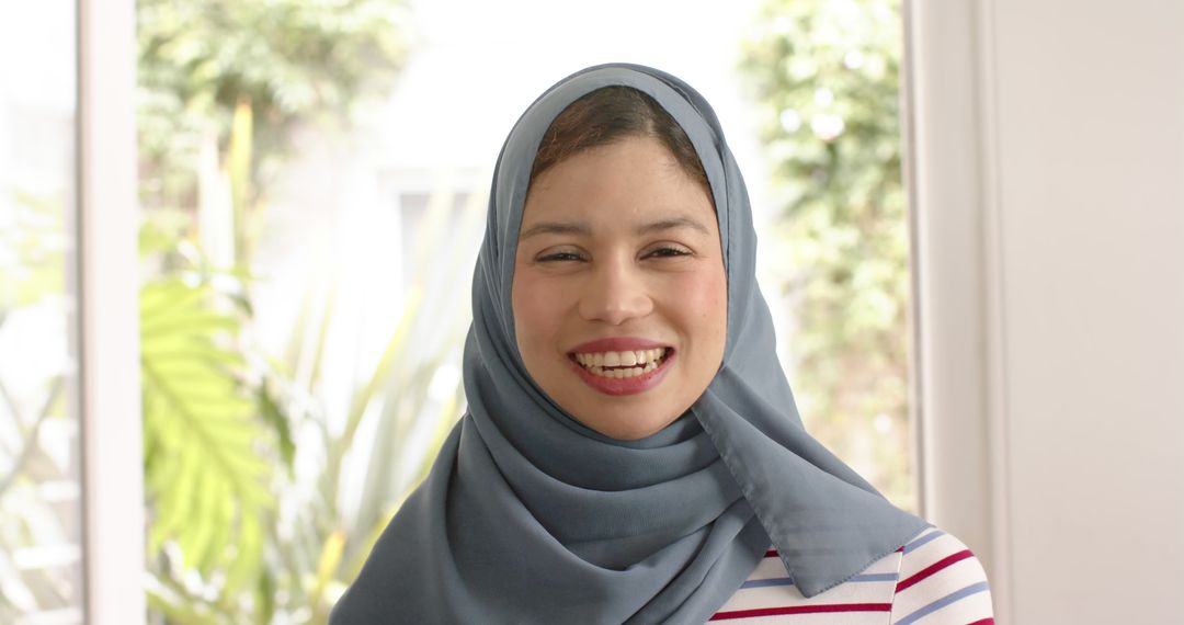 Smiling Woman in Hijab in Bright Room - Free Images, Stock Photos and Pictures on Pikwizard.com