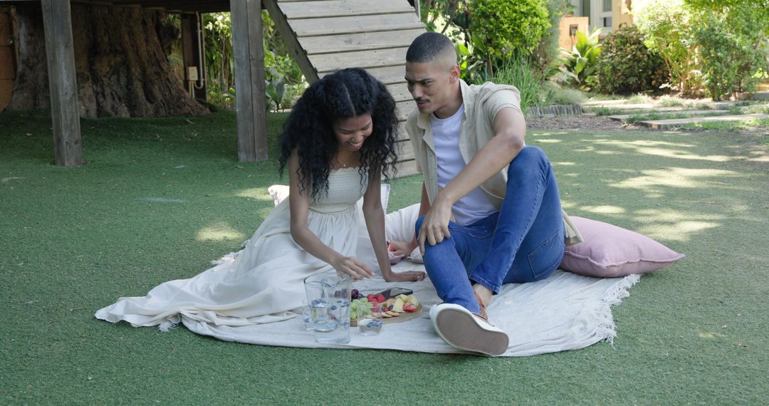Diverse Couple Enjoying Relaxing Picnic Together in Sunlit Garden