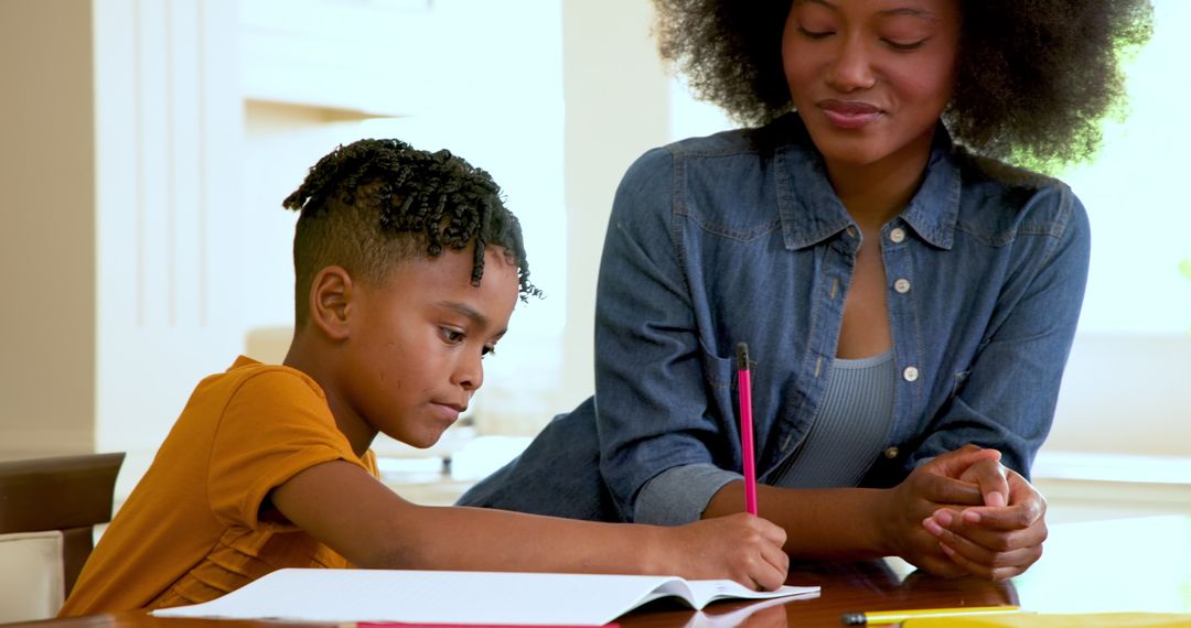 Mother Helping Multiracial Son with Homework at Home