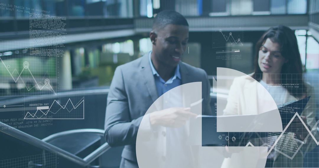 Midcareer Professionals Analyzing Digital Charts on Laptop in Corporate Setting