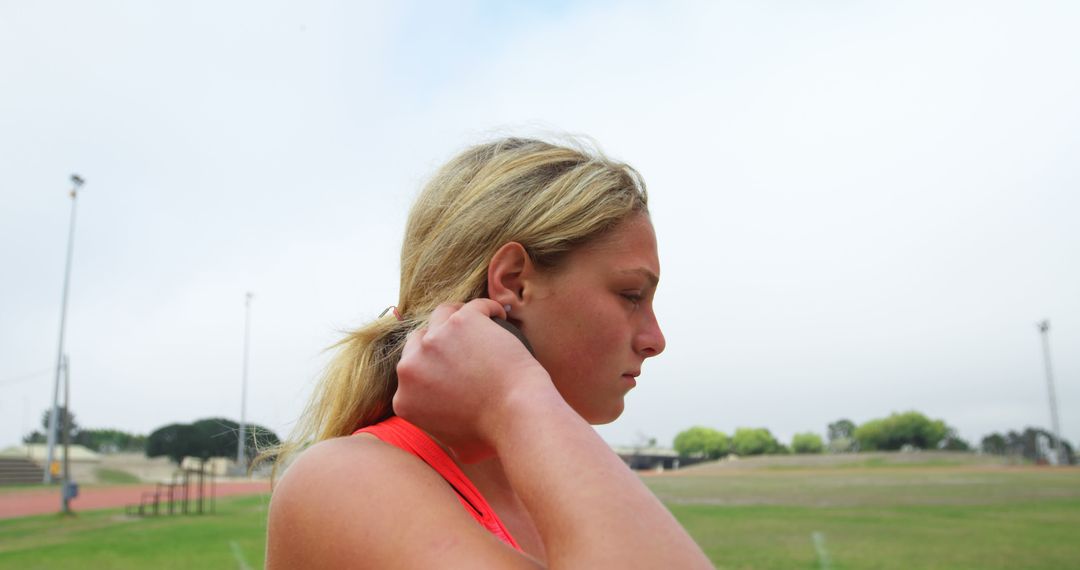 Focused Female Athlete Preparing for Shot Put Throw Outdoors - Free Images, Stock Photos and Pictures on Pikwizard.com