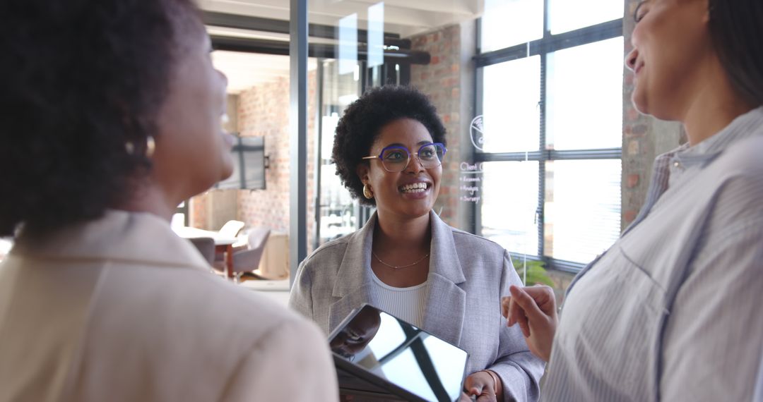 Diverse Women Collaborating in a Modern Office with Technology