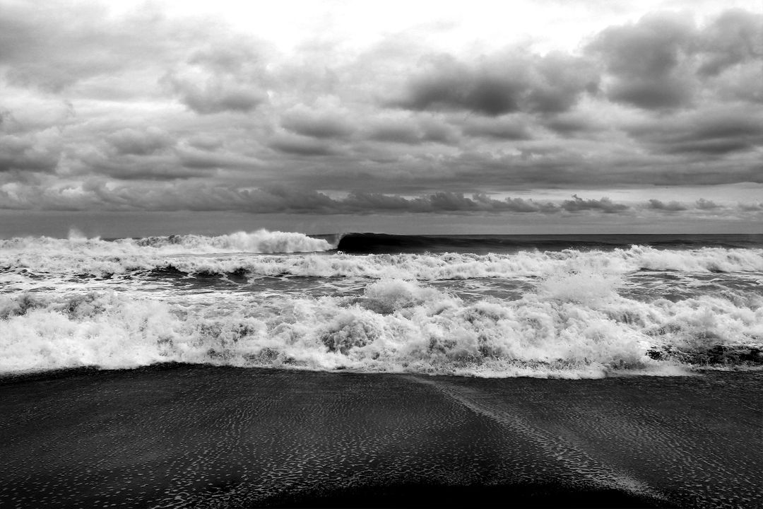 Black and white stormy ocean waves crashing on beach under dramatic clouds - Free Images, Stock Photos and Pictures on Pikwizard.com